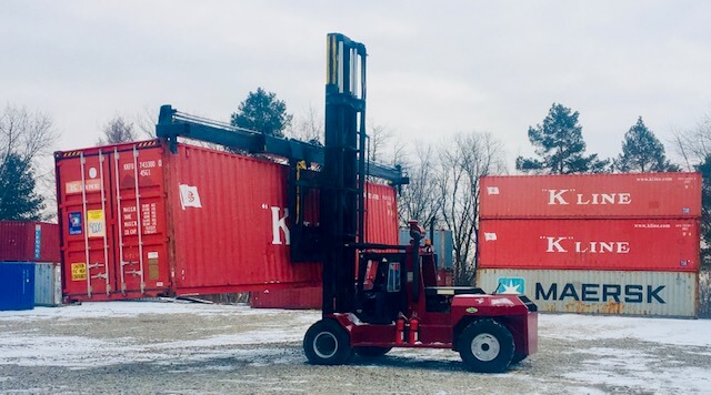 Forklift transporting storage containers