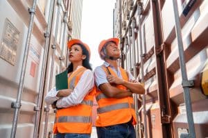 Image of two construction workers at a jobsite standing between storage containers on Storage On-Site's website