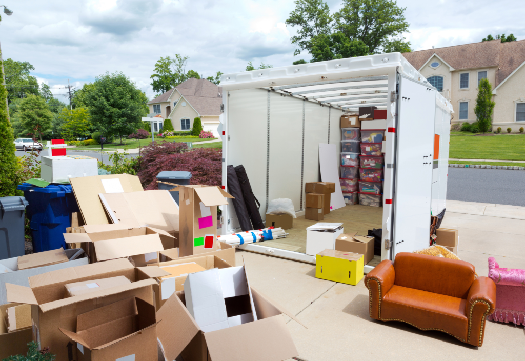 Image of an open storage container in front of a house with residential storage items around it