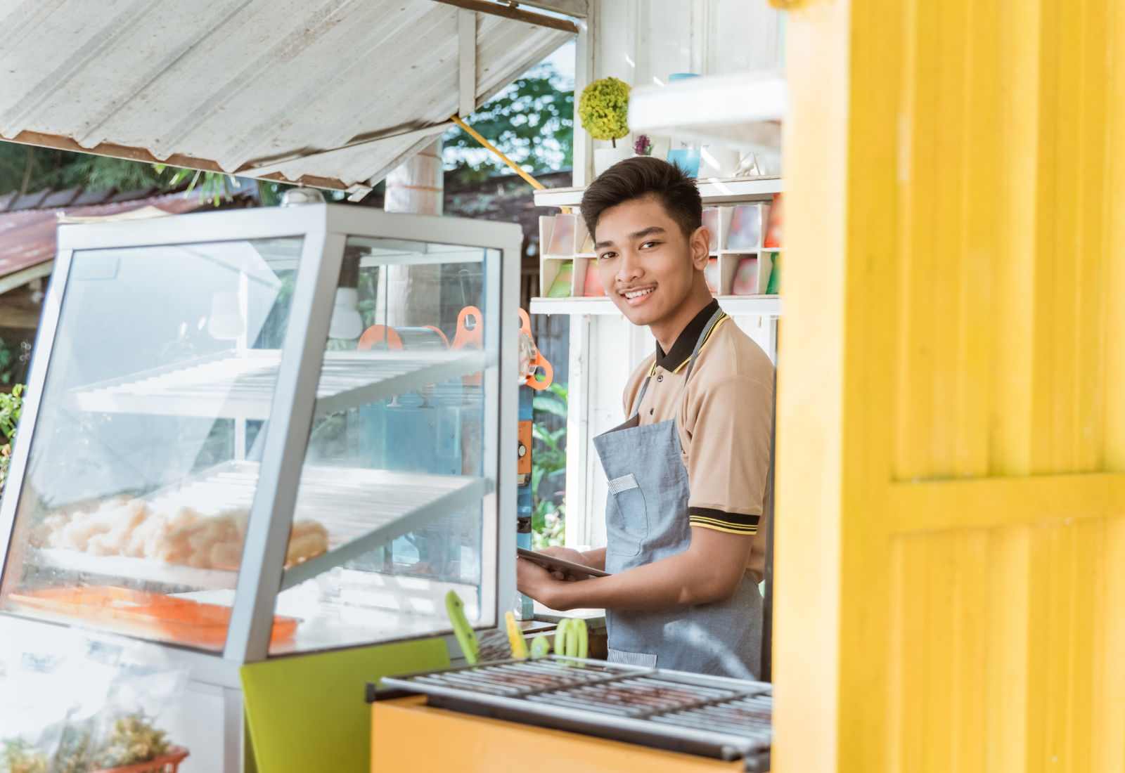 Image of a man working in a storage container cafe